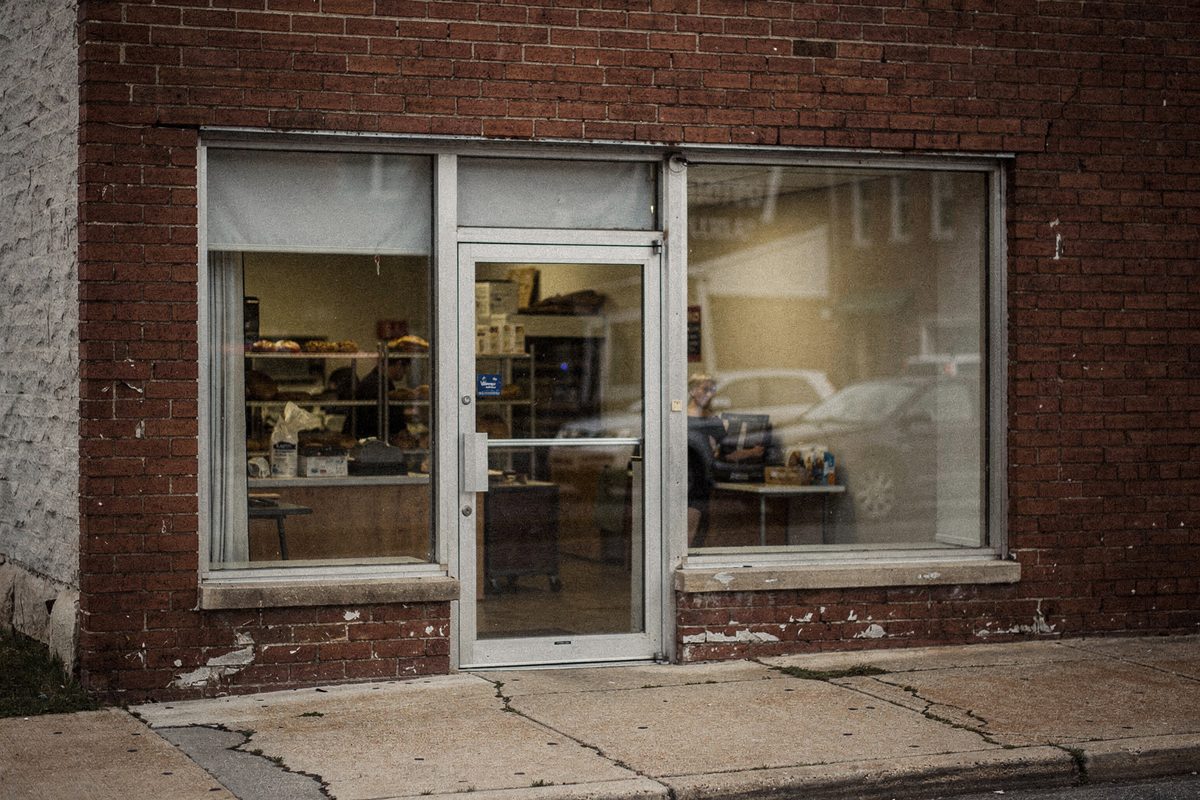 Brick storefront entrance of the bakery in early morning light